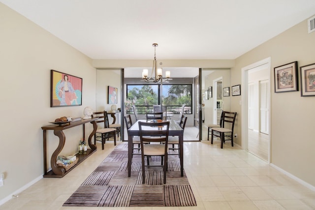 dining area with light tile patterned flooring, visible vents, baseboards, and an inviting chandelier