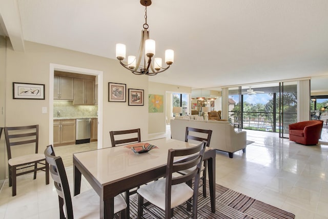 dining room featuring expansive windows and ceiling fan with notable chandelier