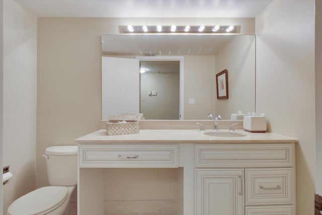 bathroom with toilet, visible vents, and vanity