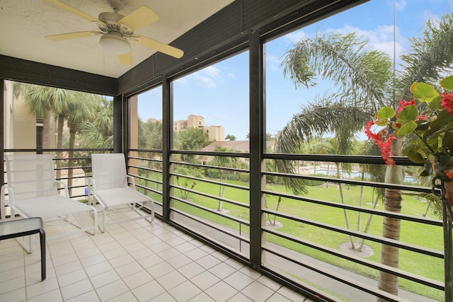 unfurnished sunroom featuring a ceiling fan