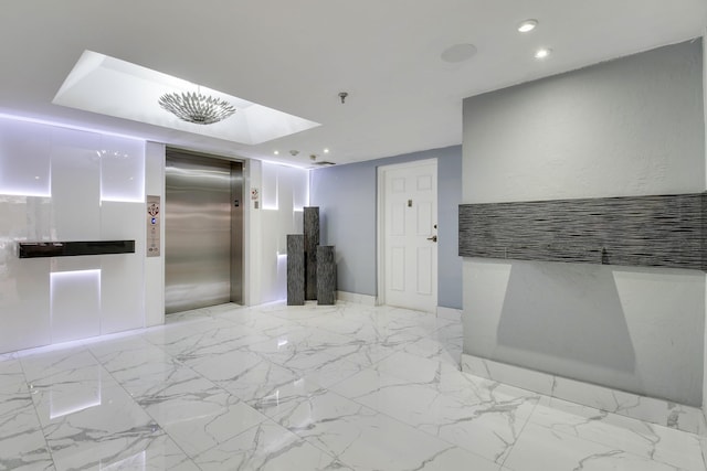 interior space featuring marble finish floor, recessed lighting, and elevator