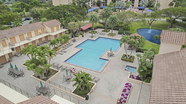 view of pool featuring a patio and a water view