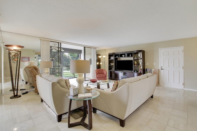 living room featuring light tile patterned floors, a wall of windows, and a textured ceiling