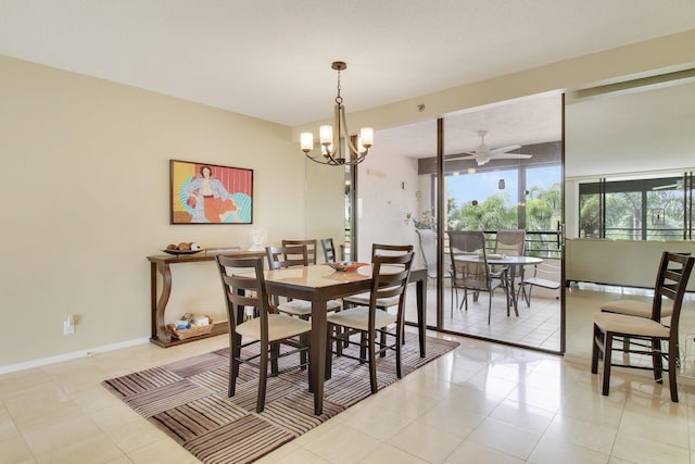 tiled dining area featuring ceiling fan with notable chandelier and baseboards