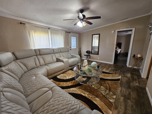 living room with ornamental molding, visible vents, a textured ceiling, and wood finished floors