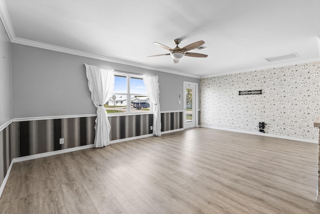 unfurnished living room with crown molding, wood finished floors, and ceiling fan