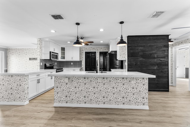 kitchen featuring light countertops, white cabinets, visible vents, and appliances with stainless steel finishes