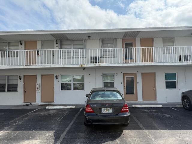 view of property featuring uncovered parking