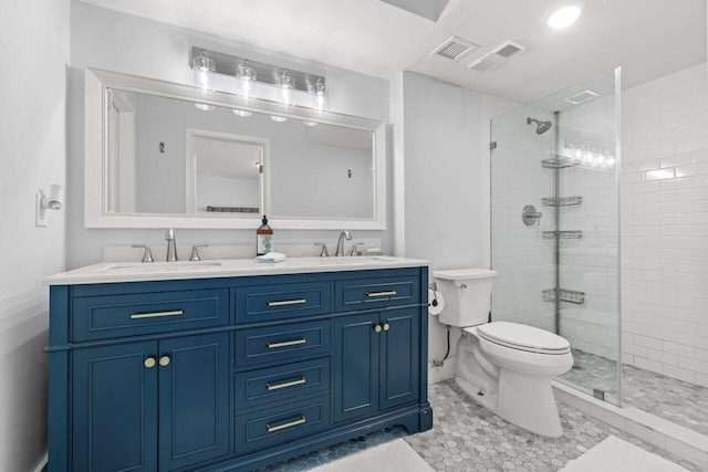 bathroom with toilet, a stall shower, visible vents, and a sink