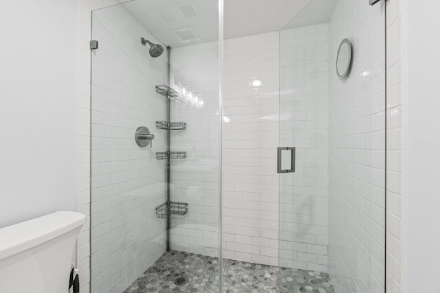 full bath with a shower stall and toilet