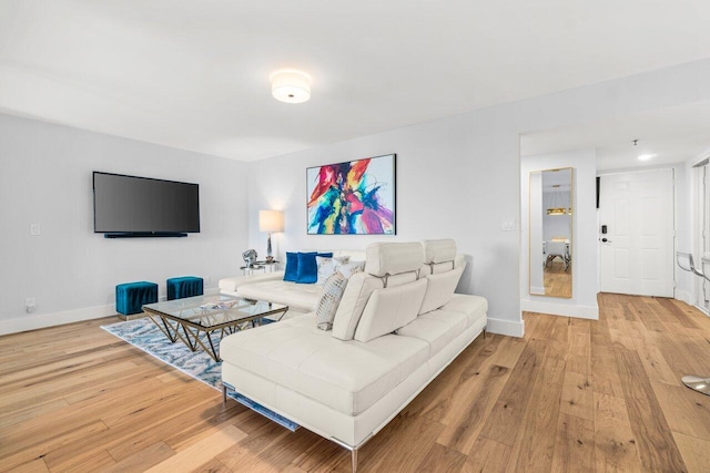 living area with baseboards and light wood-style floors