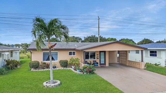 single story home with an attached carport, a front yard, roof with shingles, driveway, and stucco siding