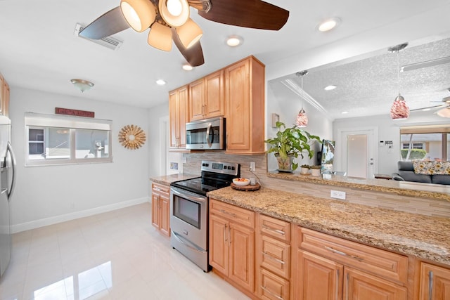 kitchen featuring light stone counters, baseboards, ceiling fan, appliances with stainless steel finishes, and backsplash