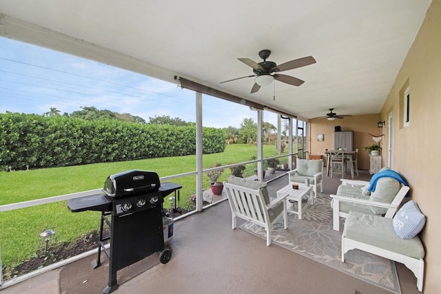 sunroom featuring ceiling fan