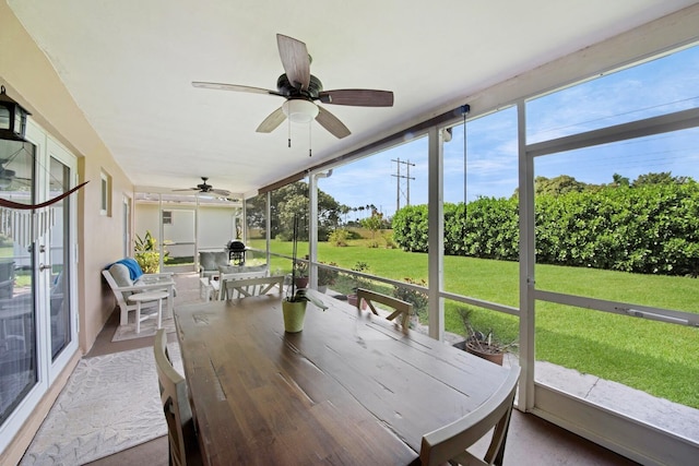 sunroom / solarium featuring ceiling fan