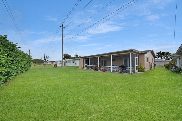 view of yard featuring a sunroom