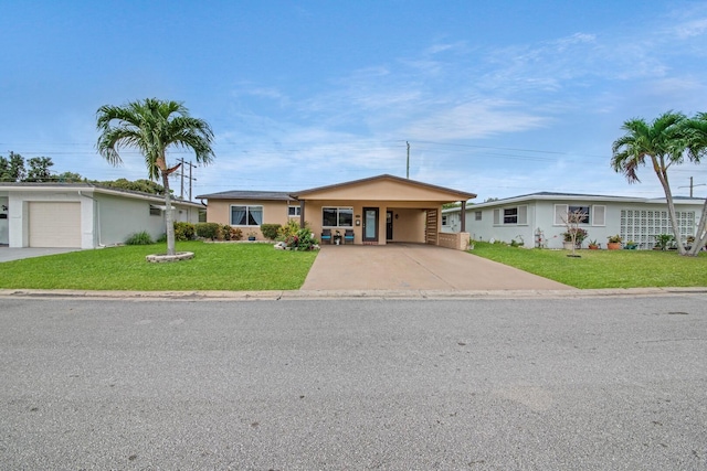 ranch-style house featuring stucco siding, driveway, a carport, and a front lawn