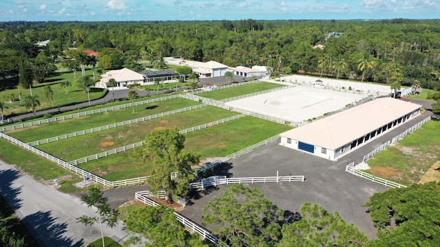 drone / aerial view featuring a rural view and a wooded view