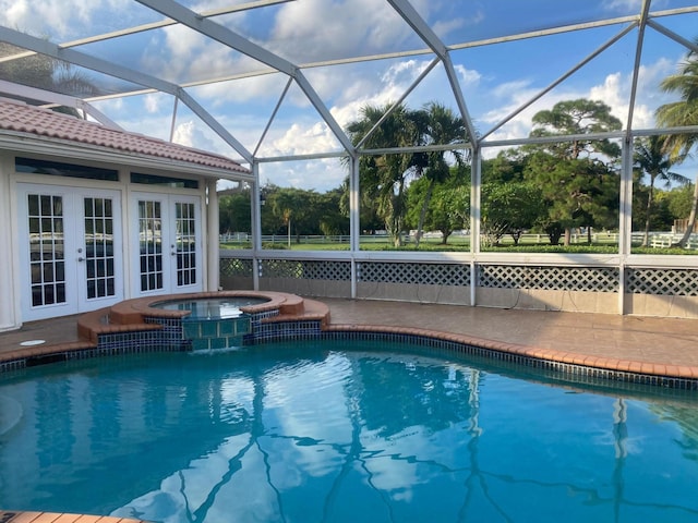 view of swimming pool with french doors, a pool with connected hot tub, and a lanai