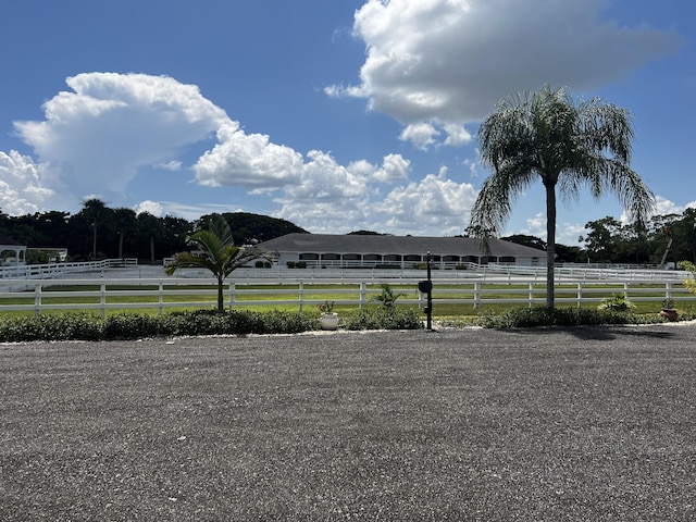 view of yard with a rural view and fence