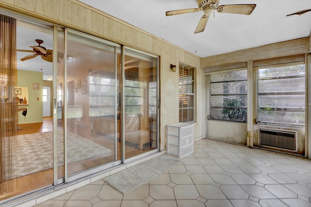 unfurnished sunroom with ceiling fan and plenty of natural light