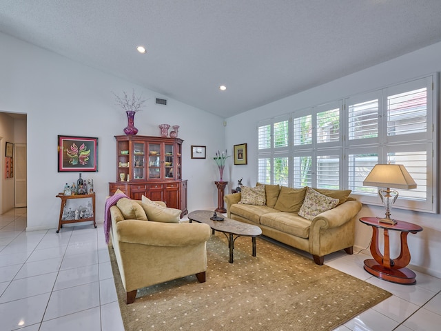 living room with lofted ceiling, light tile patterned floors, recessed lighting, and visible vents