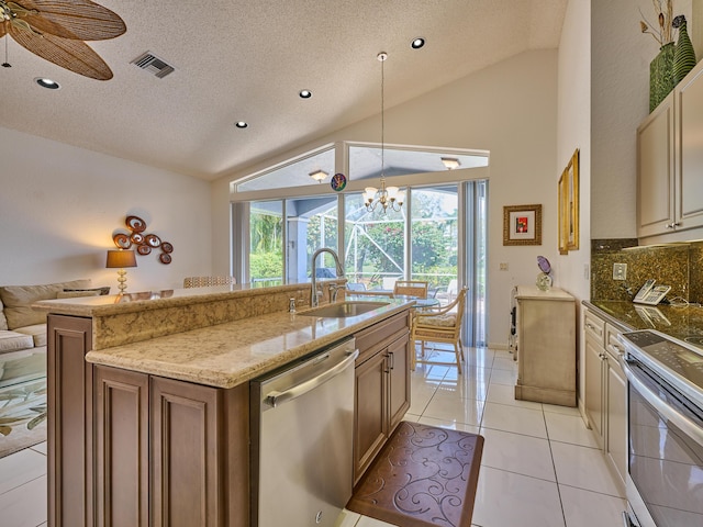 kitchen featuring visible vents, lofted ceiling, light tile patterned flooring, stainless steel appliances, and a sink