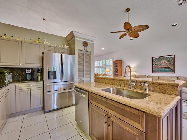 kitchen featuring tasteful backsplash, visible vents, open floor plan, appliances with stainless steel finishes, and a sink