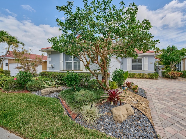 view of front of home with a garage and stucco siding