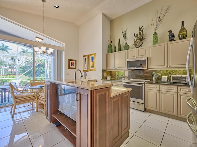 kitchen with backsplash, light tile patterned floors, stainless steel appliances, high vaulted ceiling, and a kitchen island with sink