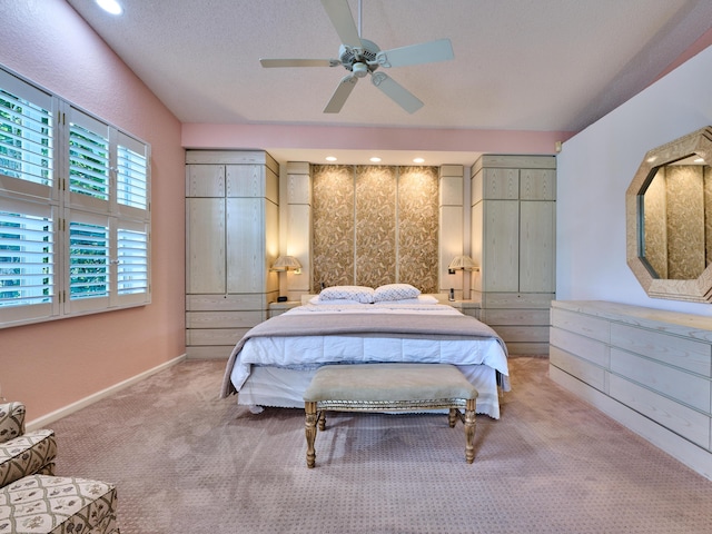 bedroom with ceiling fan, baseboards, and light carpet