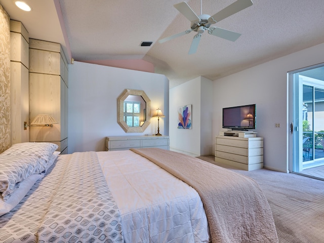 carpeted bedroom featuring visible vents, lofted ceiling, a textured ceiling, a ceiling fan, and access to outside