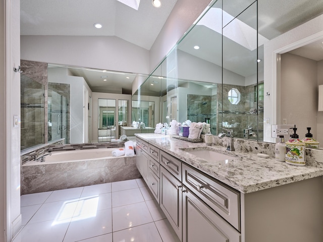 bathroom with vaulted ceiling with skylight, a shower stall, a bath, and a sink