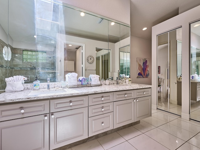 full bathroom with tile patterned flooring, double vanity, recessed lighting, and a sink