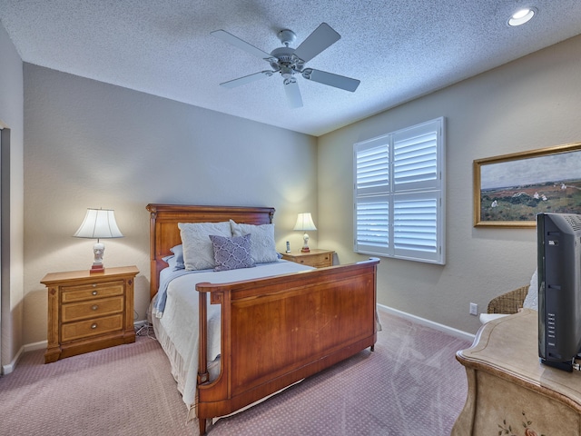 carpeted bedroom with baseboards, a textured ceiling, and ceiling fan