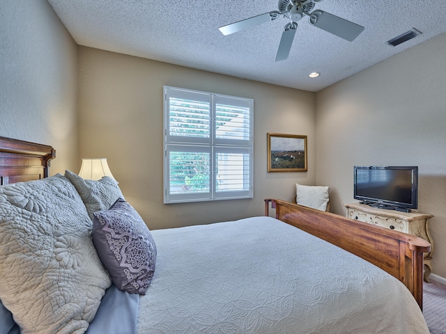 carpeted bedroom with ceiling fan, recessed lighting, visible vents, and a textured ceiling