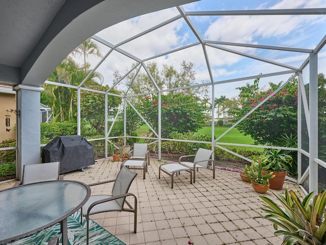 view of patio / terrace with area for grilling and glass enclosure