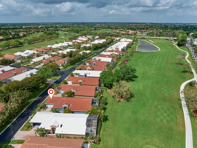 drone / aerial view featuring a residential view, a water view, and golf course view