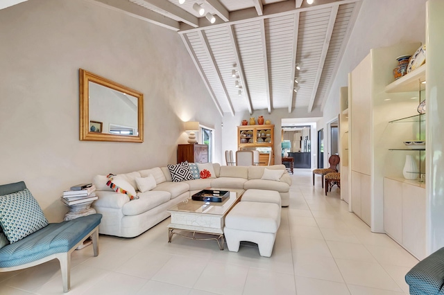 living area featuring light tile patterned floors, beamed ceiling, wooden ceiling, and track lighting