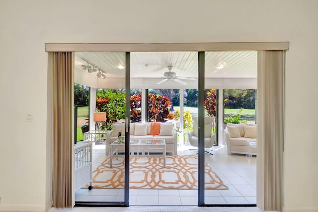 entryway with ceiling fan, a healthy amount of sunlight, and tile patterned floors