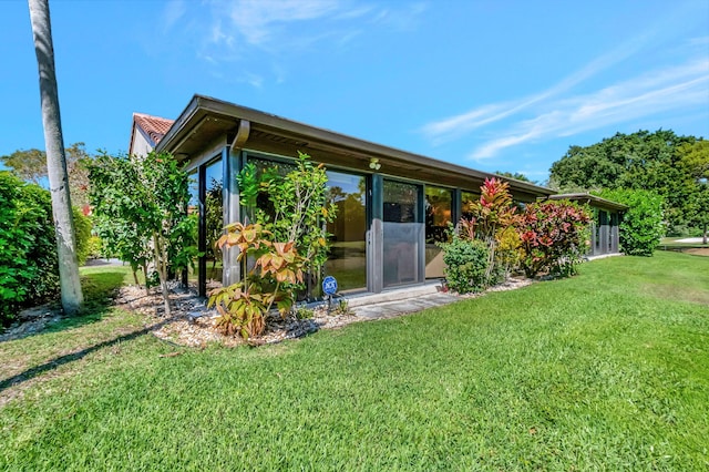 rear view of property with a yard