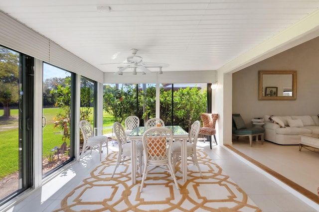 sunroom featuring a ceiling fan and a wealth of natural light