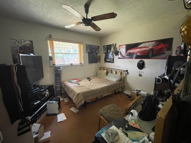 bedroom featuring a ceiling fan, carpet, and a textured ceiling