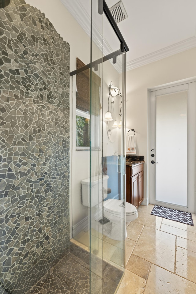 full bathroom featuring vanity, stone tile floors, a stall shower, ornamental molding, and toilet