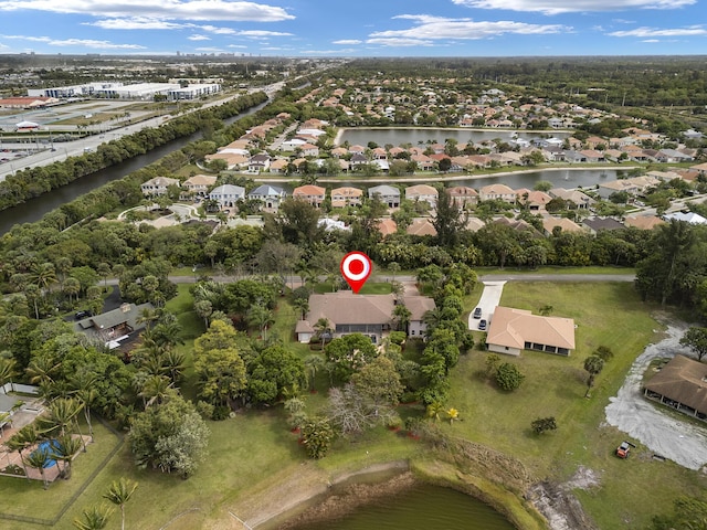 drone / aerial view with a residential view and a water view