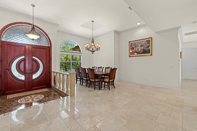 entryway featuring an inviting chandelier, baseboards, and ornamental molding