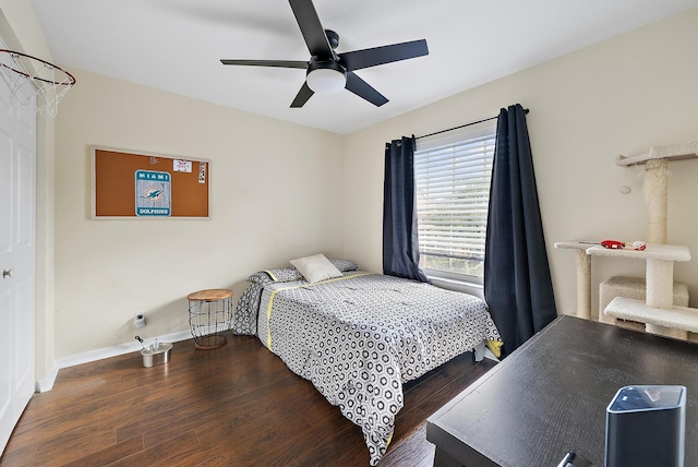 bedroom featuring ceiling fan, baseboards, and wood finished floors