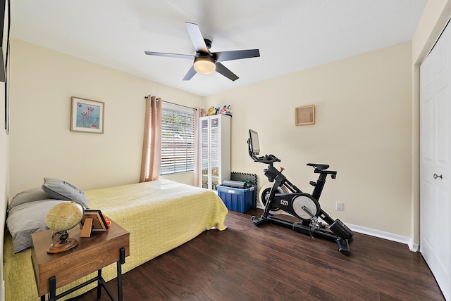 bedroom with ceiling fan, wood finished floors, and baseboards