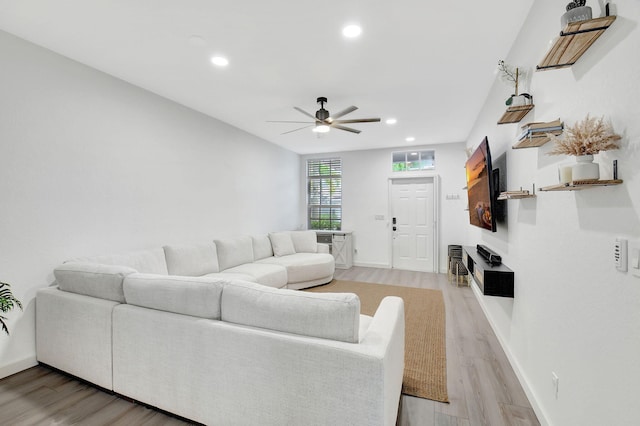 living area with light wood finished floors, baseboards, a ceiling fan, and recessed lighting