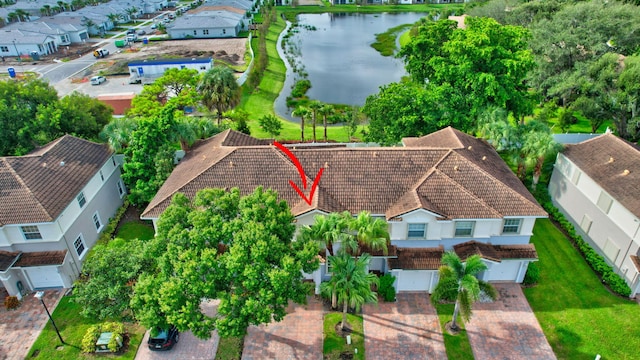 drone / aerial view with a water view and a residential view